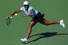 Asha Rolle reaches to hit a defensive forehand.jpg