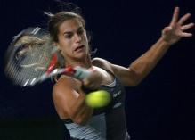 Amelie Mauresmo hits a topspin forehand.jpg