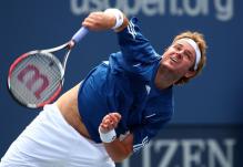 mardy fish serve follow-through.jpg
