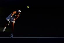 martina hingis serve follow-through.jpg